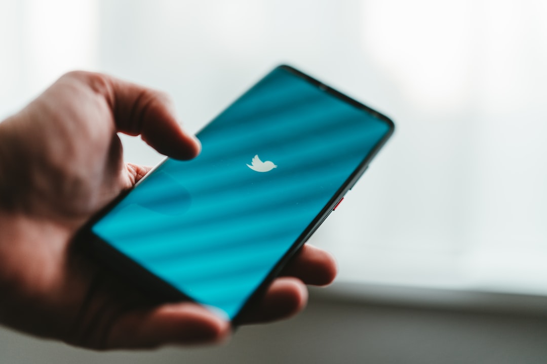 a person holding a smart phone in their hand