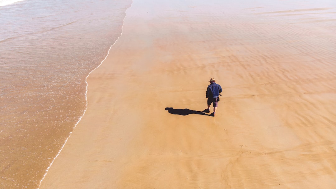 man's shadow reflecting on shore