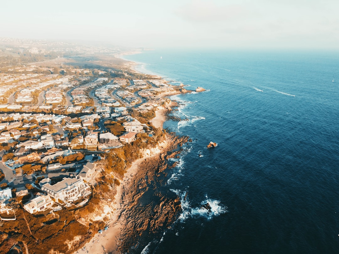 aerial view of city near body of water during daytime
