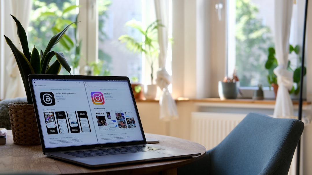 a laptop computer sitting on top of a wooden table