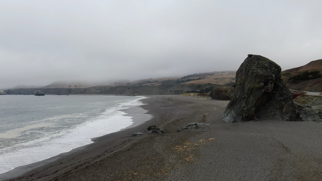 brown rock formation on sea shore during daytime