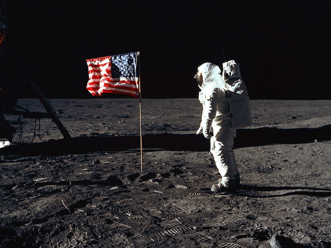 Buzz Aldrin on the moon in front of the US flag