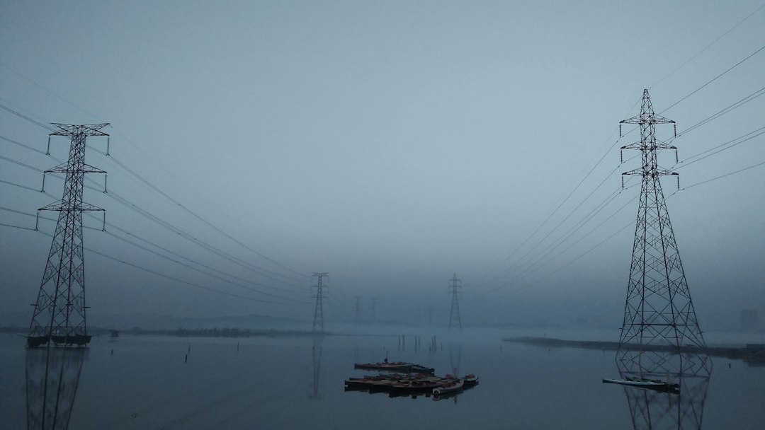a body of water surrounded by power lines