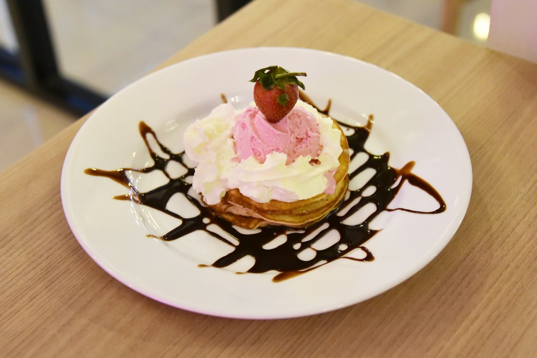 a white plate topped with a dessert covered in chocolate