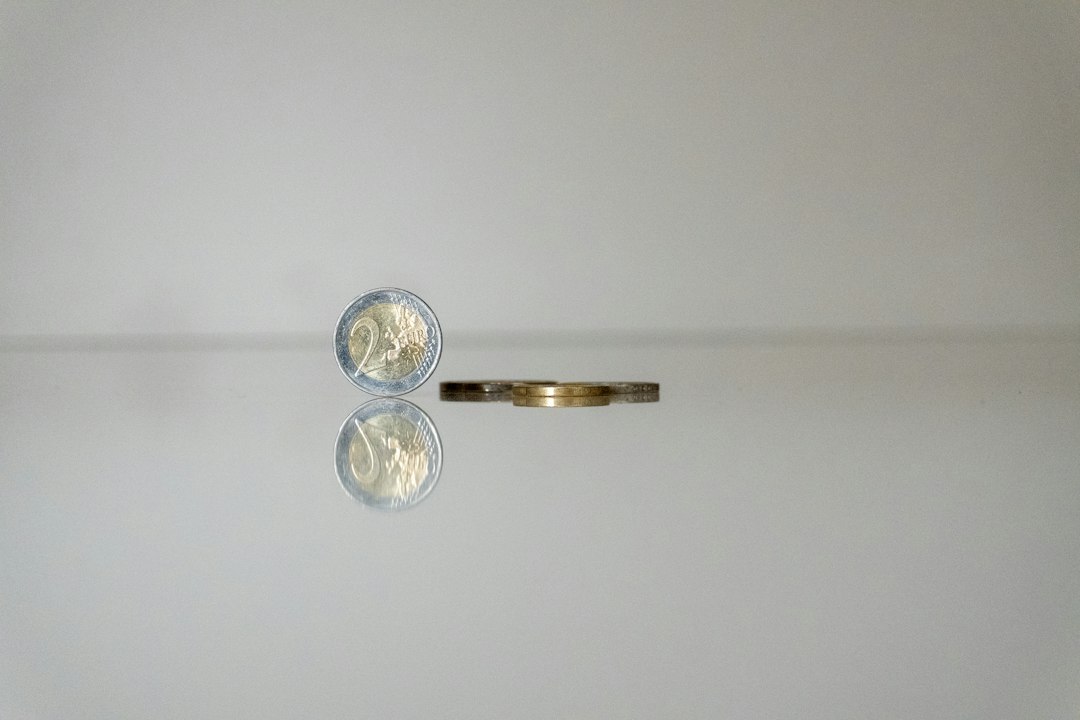 a gold ring with a coin on top of it