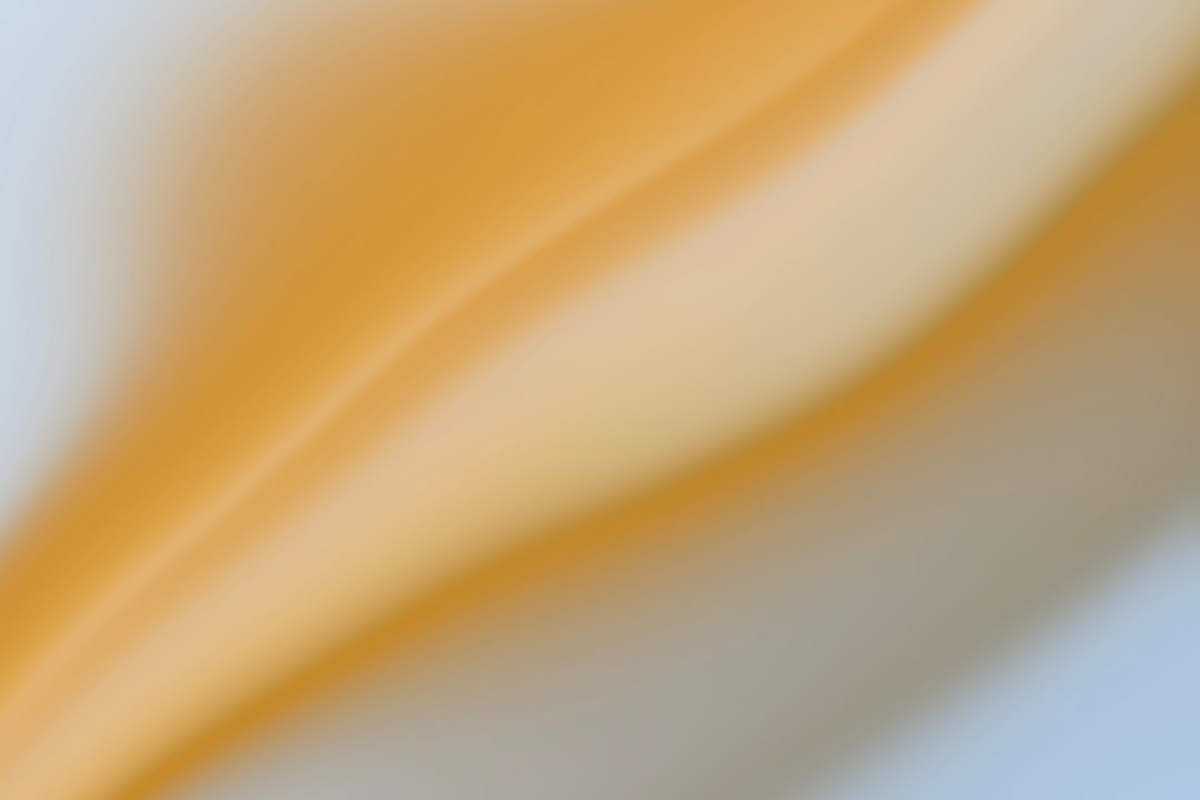 a blurry image of a yellow and white background