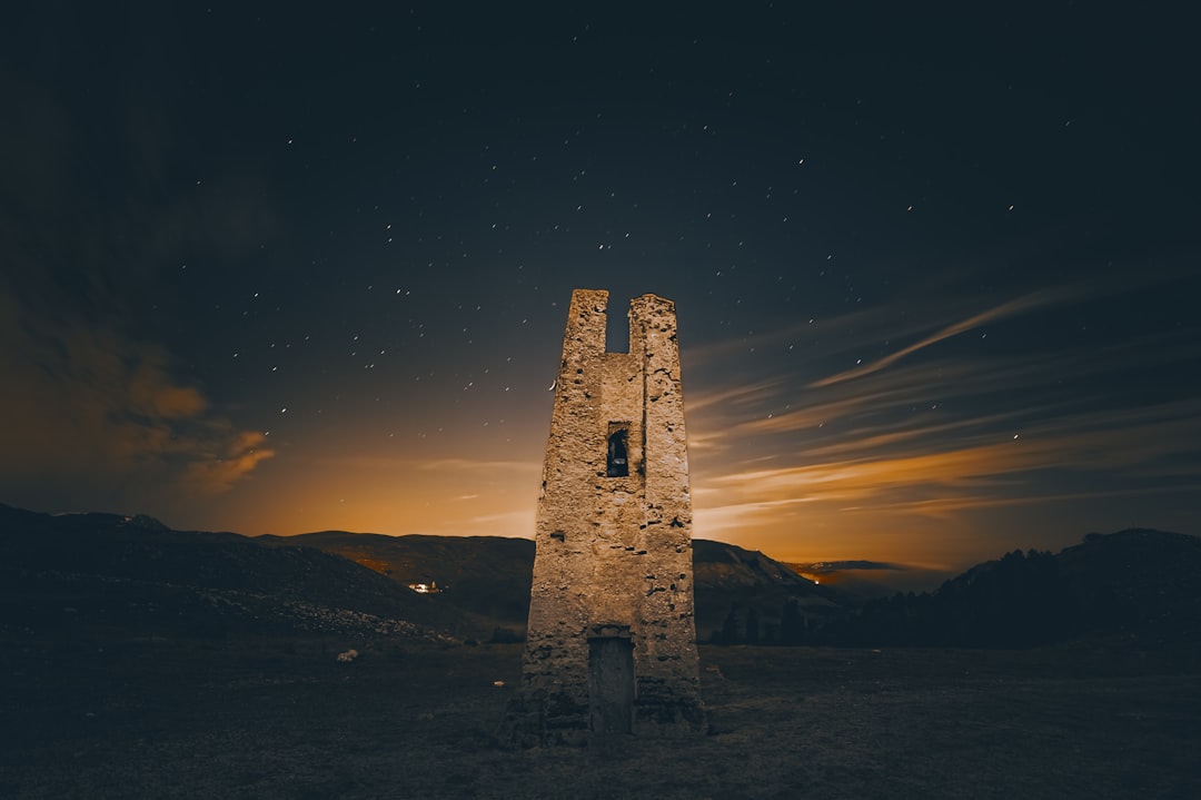 a tall tower sitting in the middle of a field