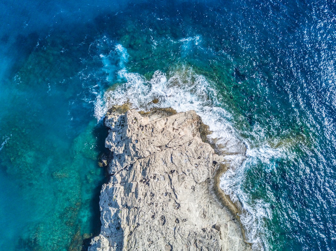 aerial view of stone beside body of water