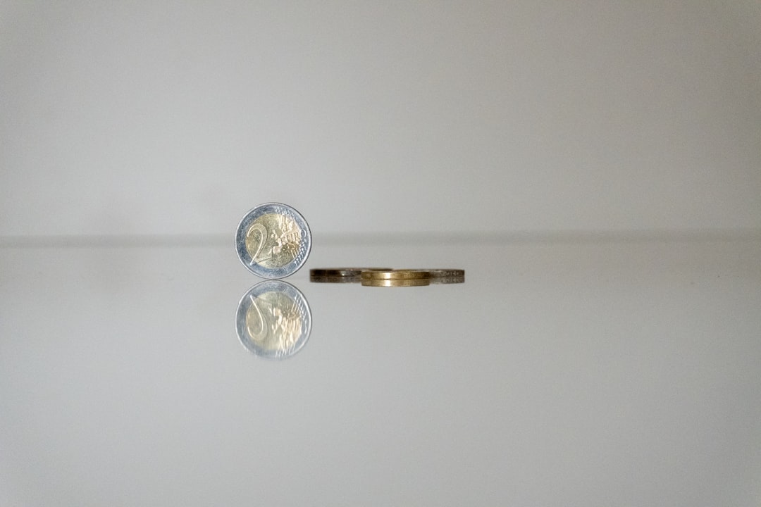 a gold ring with a coin on top of it