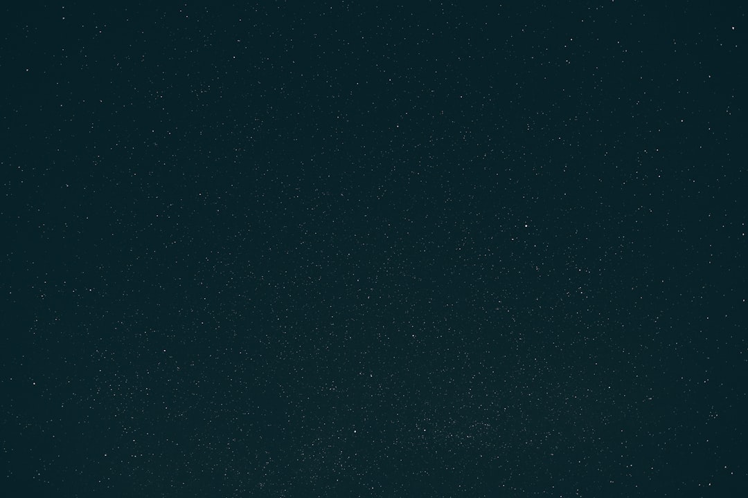 a dark blue sky with a few stars