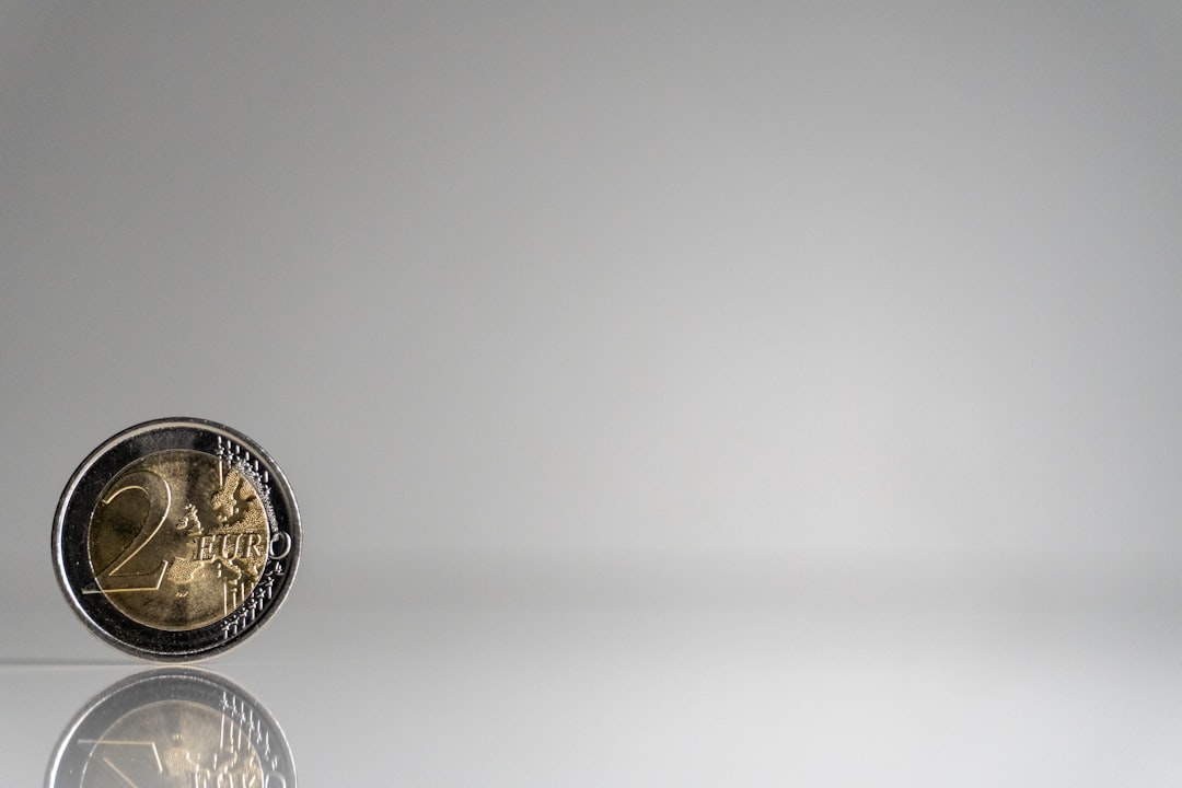 a close up of a coin on a reflective surface