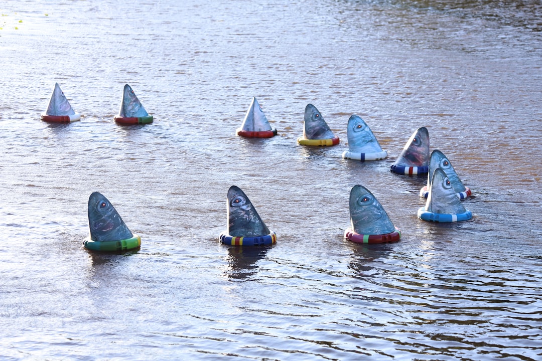 A group of small boats floating on top of a lake