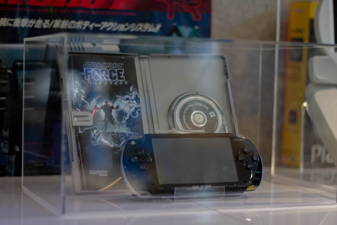 A psp and its game inside a display case.