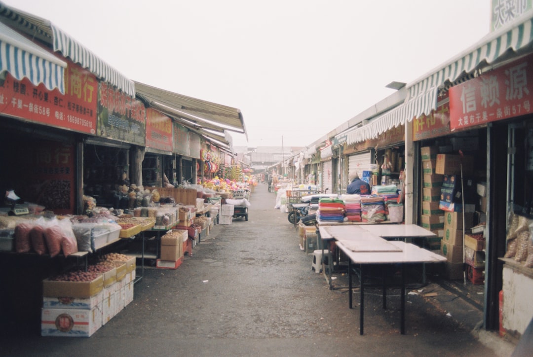 A covered market street with vendors and goods.