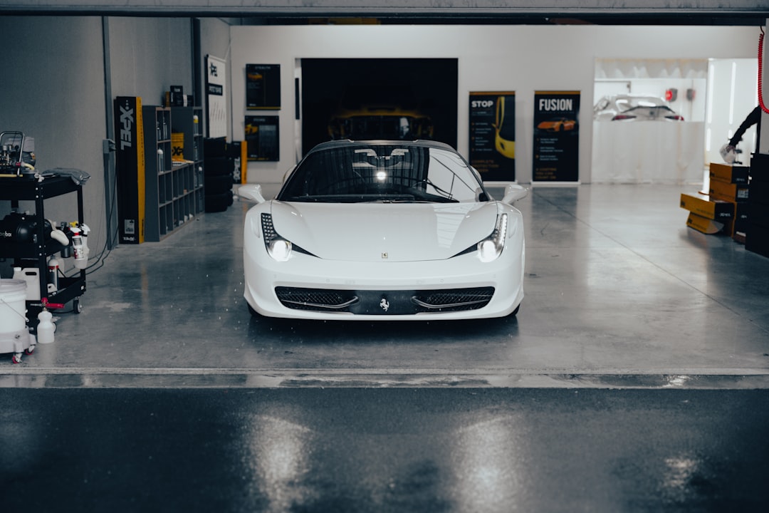 a white sports car parked in a garage