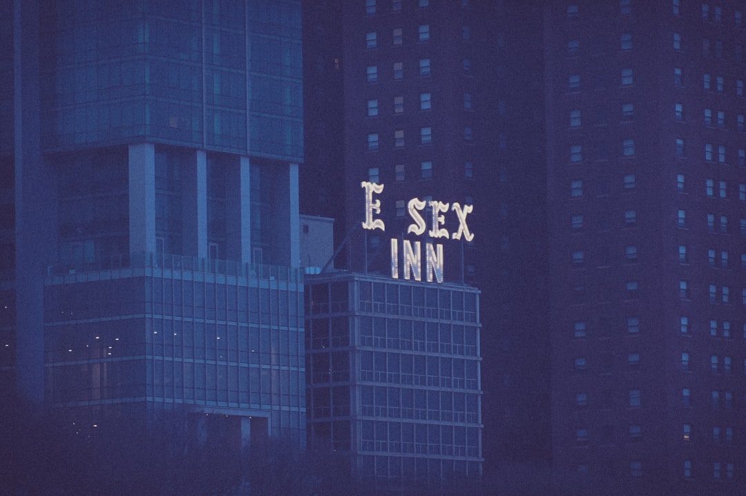 a tall building with a neon sign on top of it