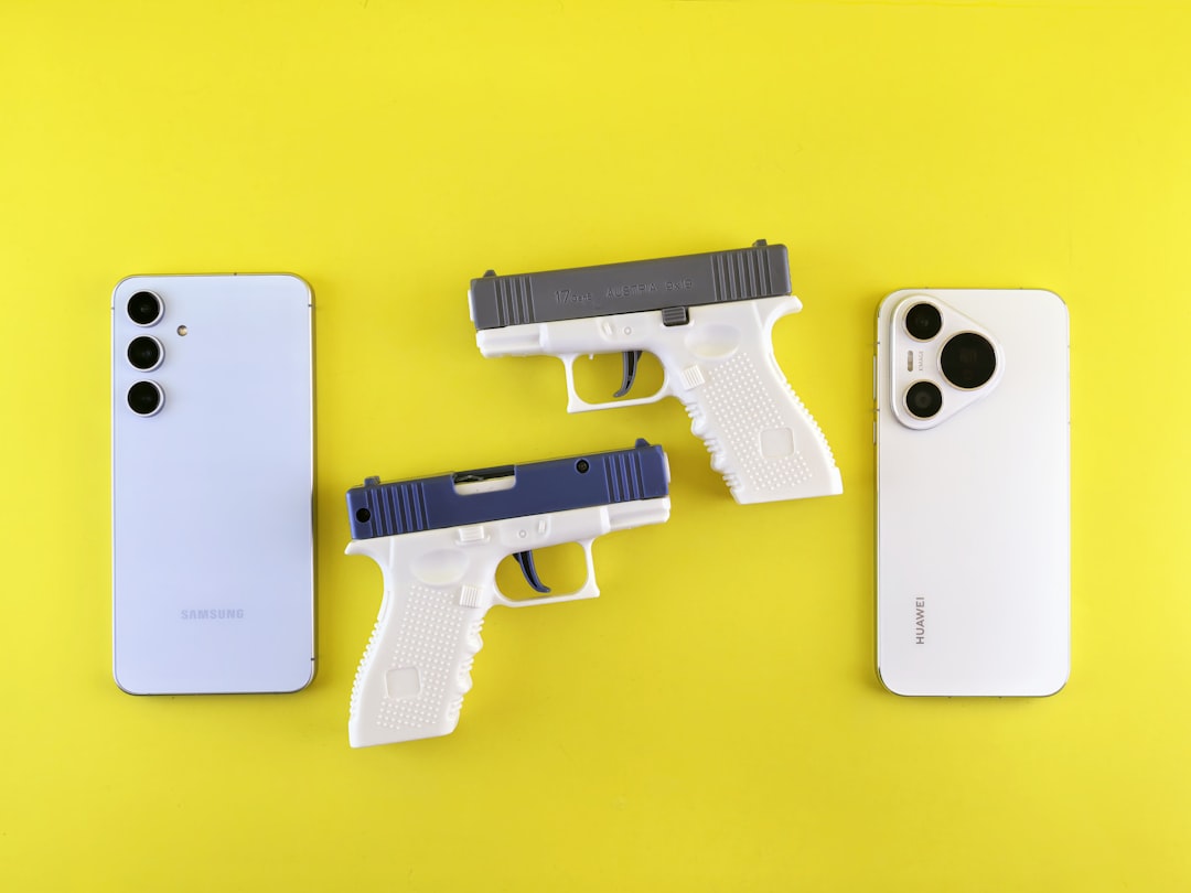 Two toy guns between two smartphones