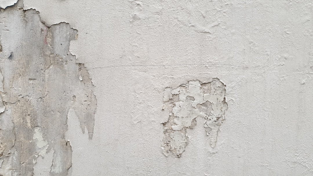 A close up of a wall with peeling paint
