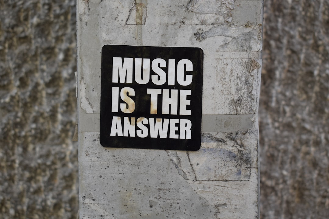 A sign on a wall that says music is the answer