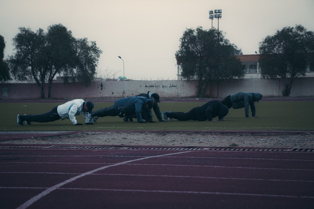 a group of people on a track doing push ups