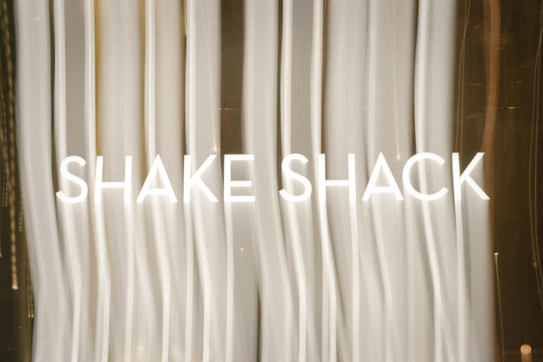 A close up of a white curtain with the words shake shack on it