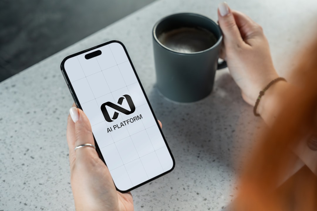 Person holding smartphone with ai platform logo.
