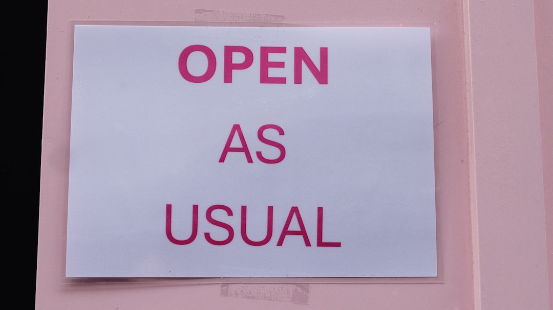A sign on a door that says open as usual