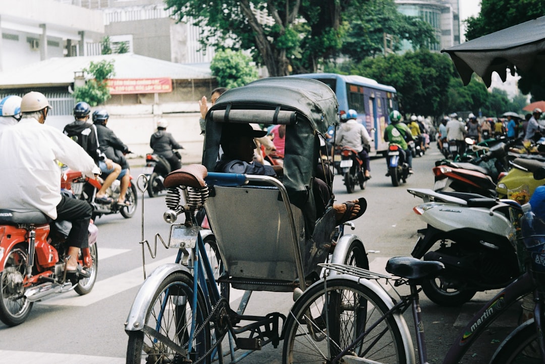 a group of people ride bikes down a busy street
